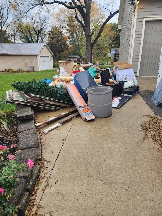 Dumpster being loaded with debris for Estate Cleanout Dumpster Rental in Geneva